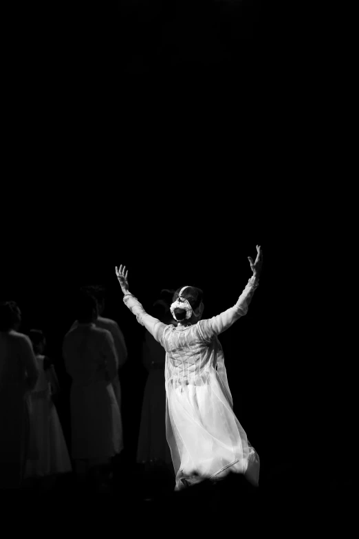 a black and white photo of a woman in a white dress, by Nathalie Rattner, unsplash, conceptual art, worship of the pope, theater dance scene, jesus, concert