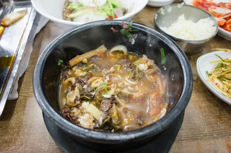 a close up of a bowl of food on a table, inspired by Byeon Sang-byeok, unsplash, mingei, square, stew, bone, thumbnail