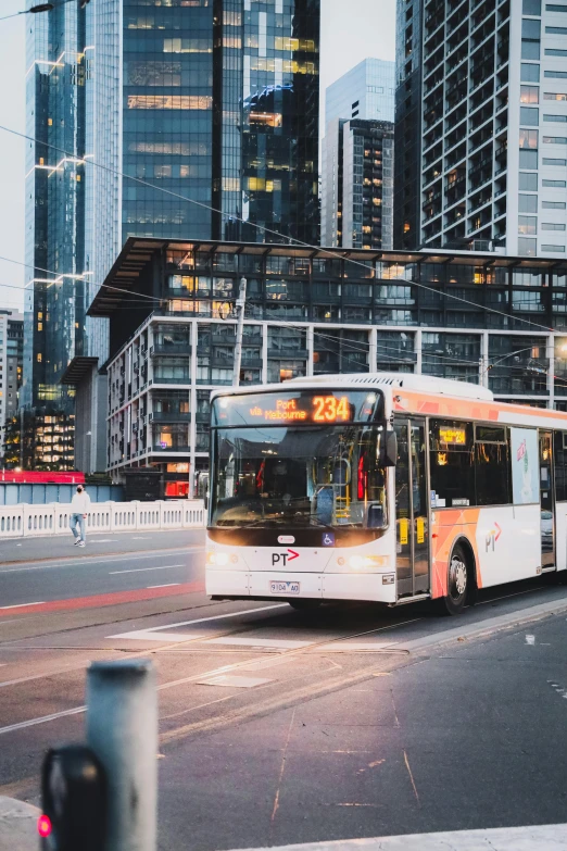 a bus driving down a city street next to tall buildings, pexels contest winner, happening, central station in sydney, thumbnail, 1 5 6 6, graphic print