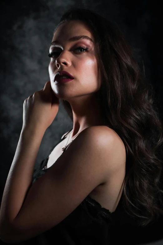 a woman in a black dress posing for a picture, dark hair and makeup, shot with sony alpha, seductive camisole, promo image