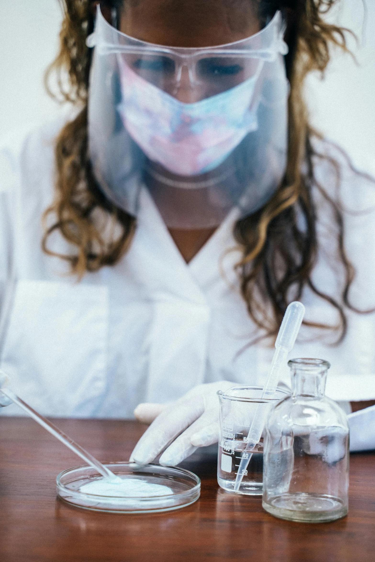 a close up of a person in a lab coat, experimenting in her science lab, masked doctors, fluids, trending photo