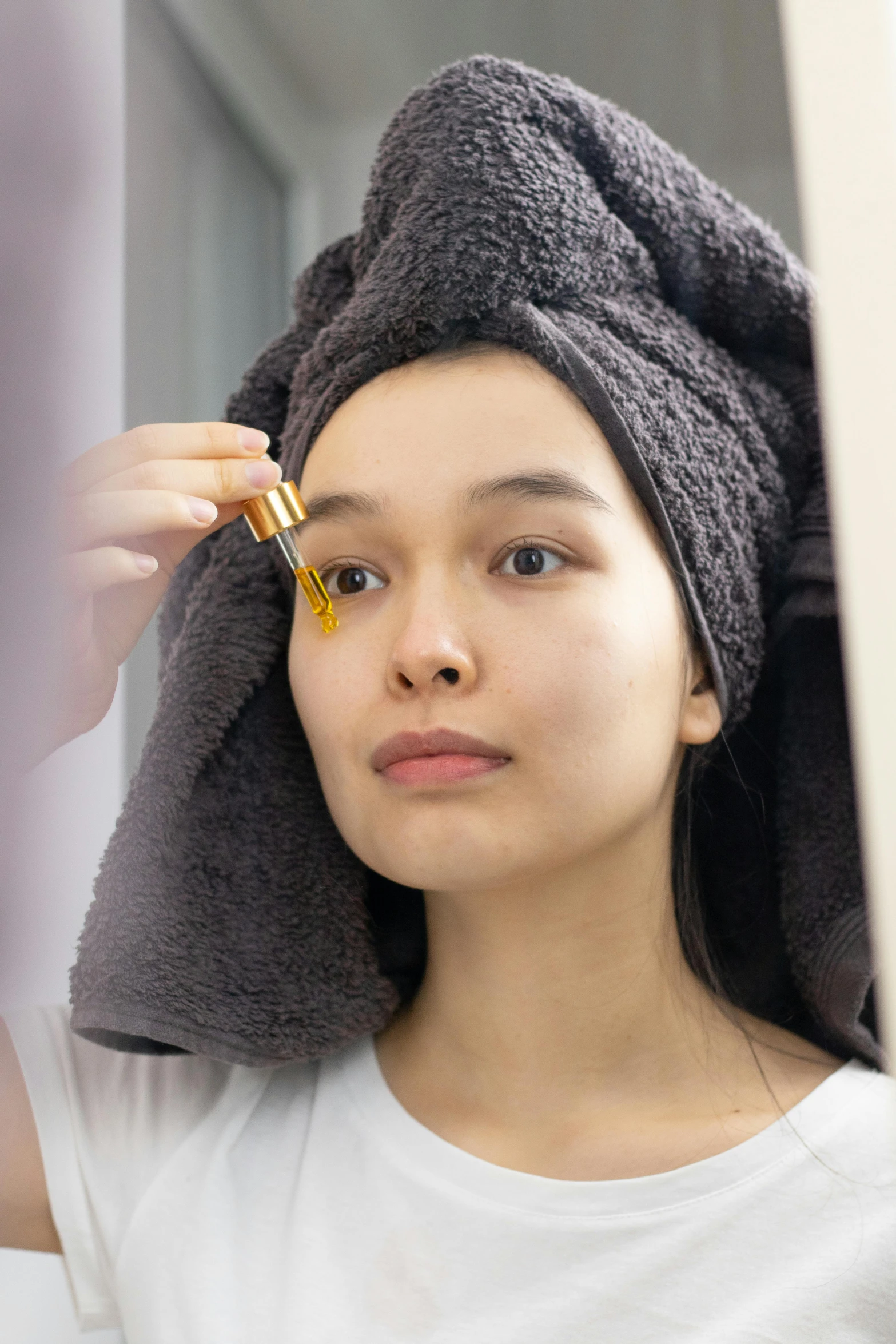 a woman with a towel wrapped around her head, a picture, mirror eye implants, straight stiff dry damaged hair, manuka, 1x