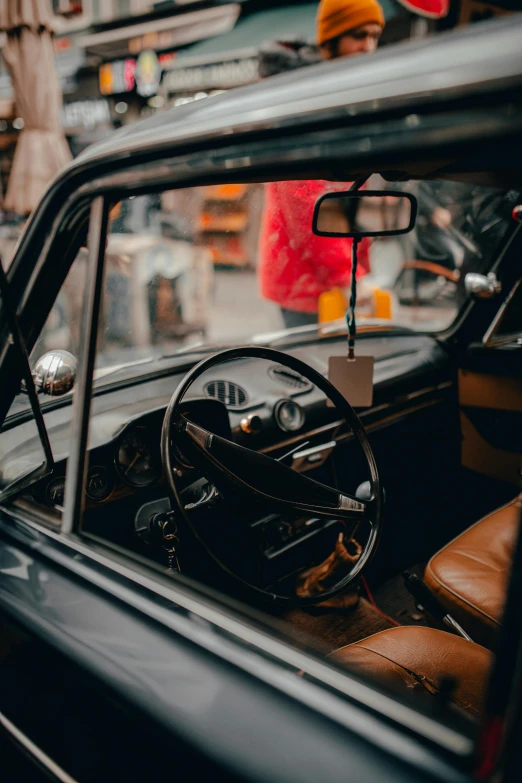 an old car parked on the side of the road, pexels contest winner, renaissance, inside of a car, fantastic vendor interior, black car, 🚿🗝📝