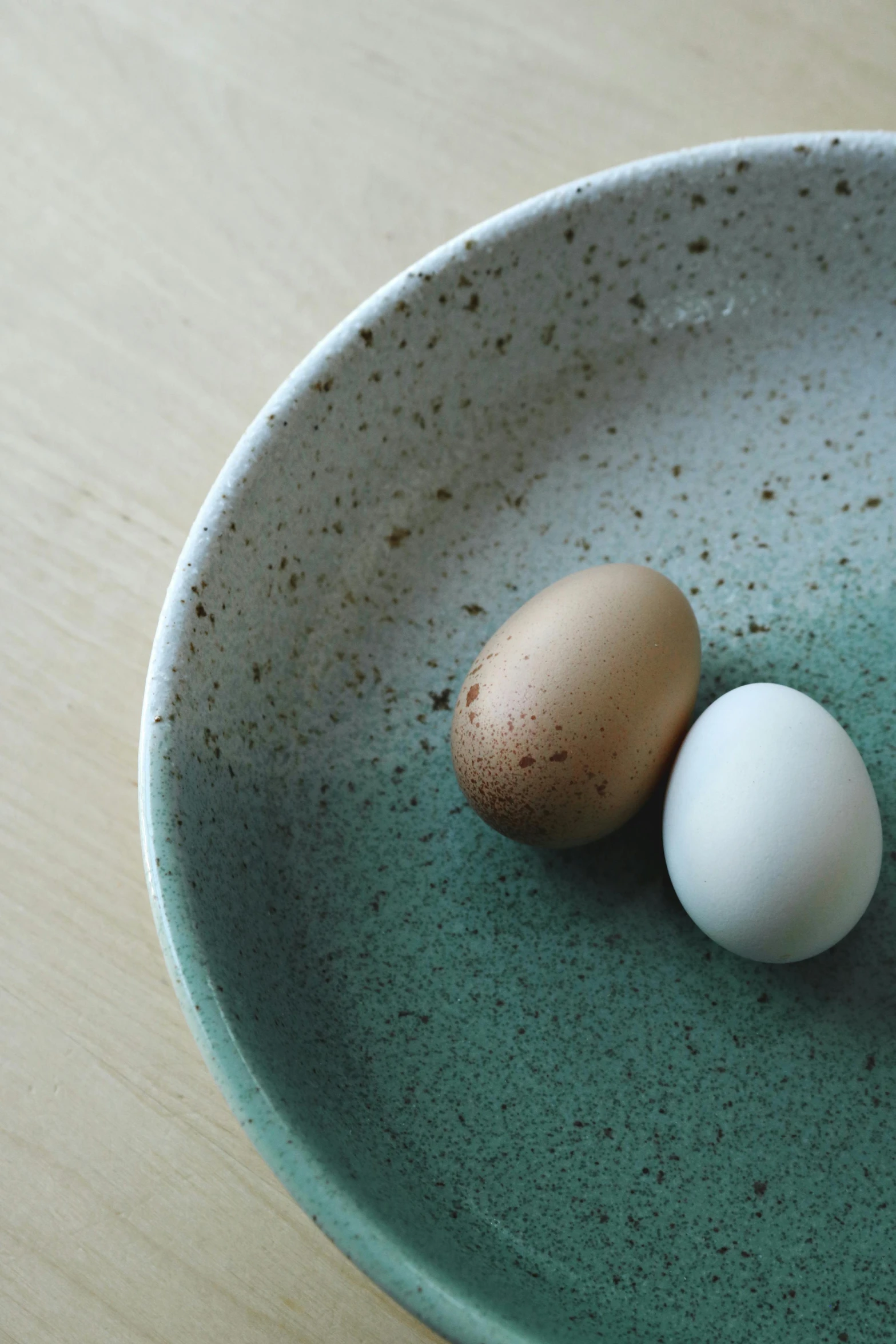 two eggs on a plate on a table, a still life, inspired by Maruyama Ōkyo, trending on unsplash, muted green, made of glazed, grain”