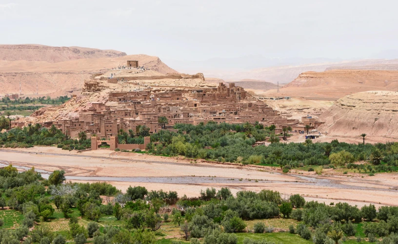 a small village in the middle of a desert, pexels contest winner, les nabis, building along a river, overlooking a valley, slide show, moroccan queens ny