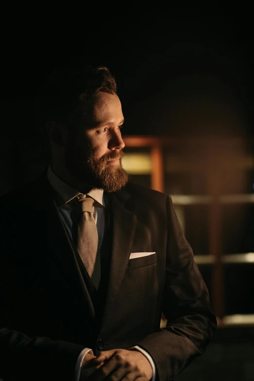 a man with a beard wearing a suit and tie, inspired by Ramon Pichot, pexels contest winner, low light cinematic, conor mcgregor, reflecting, vintage vibe