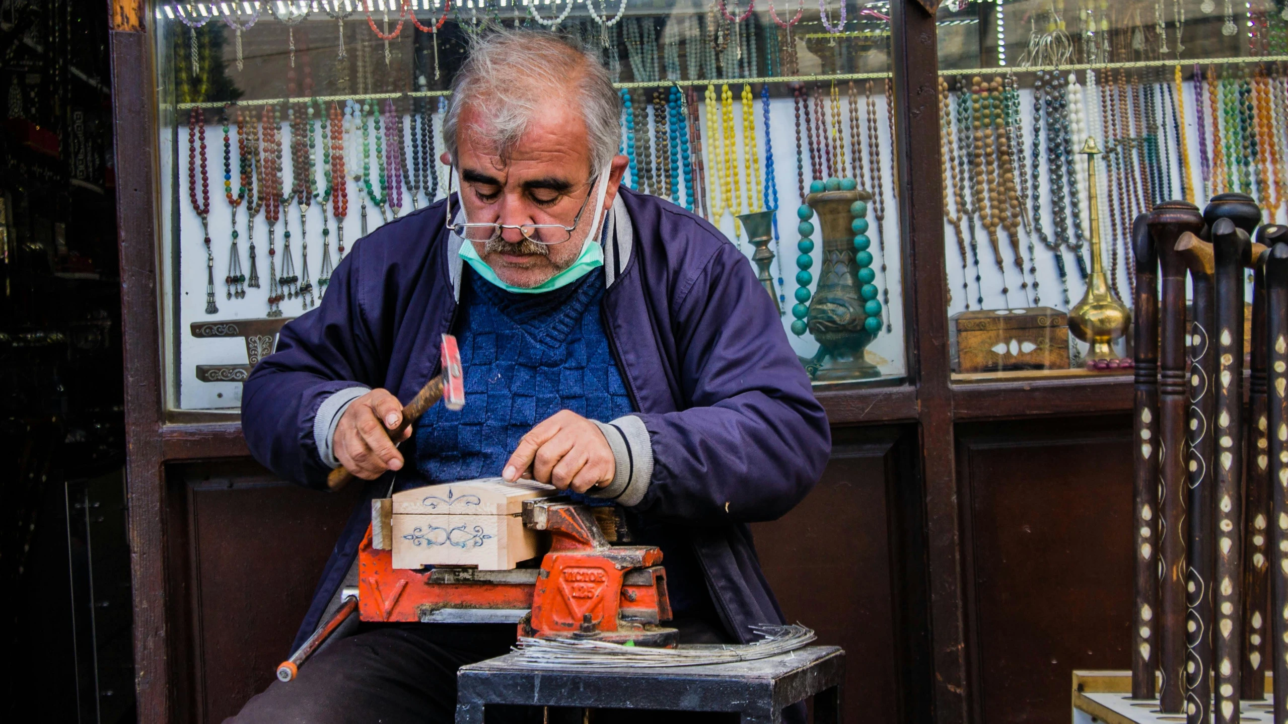 a man is working on a piece of jewelry, pexels contest winner, old town mardin, thumbnail, nice face, crafts and more