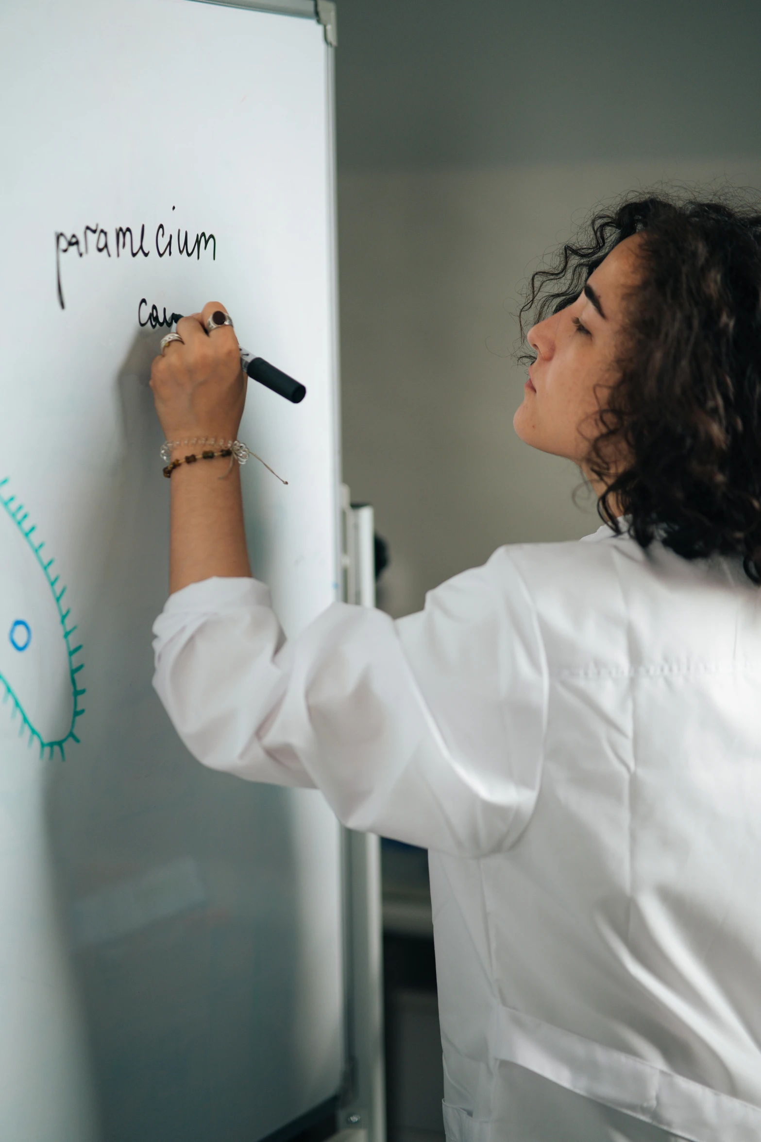 a woman writing on a white board with a marker, pexels contest winner, analytical art, lab coat, instagram story, calculus, glossy surface