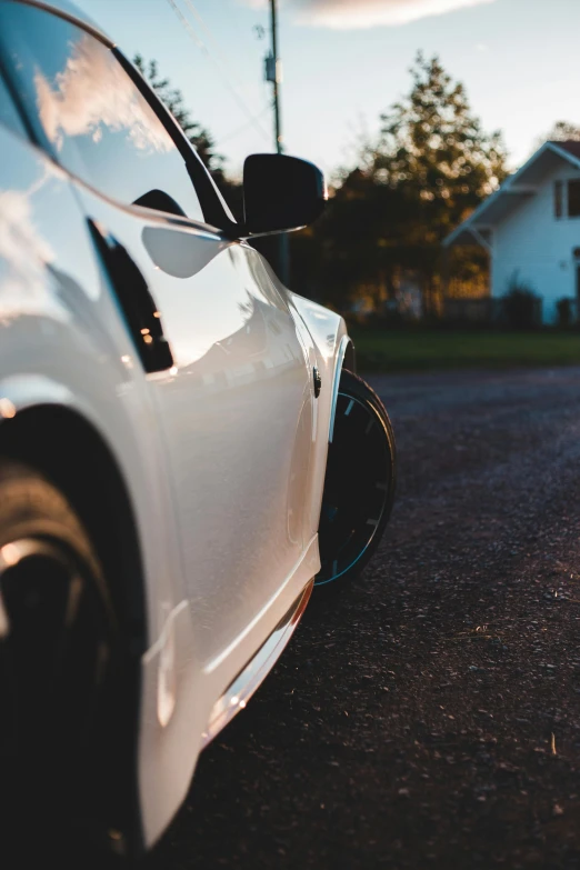 a white car parked on the side of a road, pexels contest winner, side view close up of a gaunt, avatar image, sport car, instagram photo