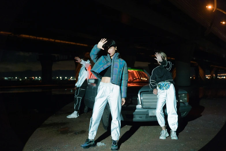 a couple of people standing next to a car, an album cover, inspired by Zhu Da, unsplash, doing a sassy pose, 2 techwear women, all from the group nct, holographic