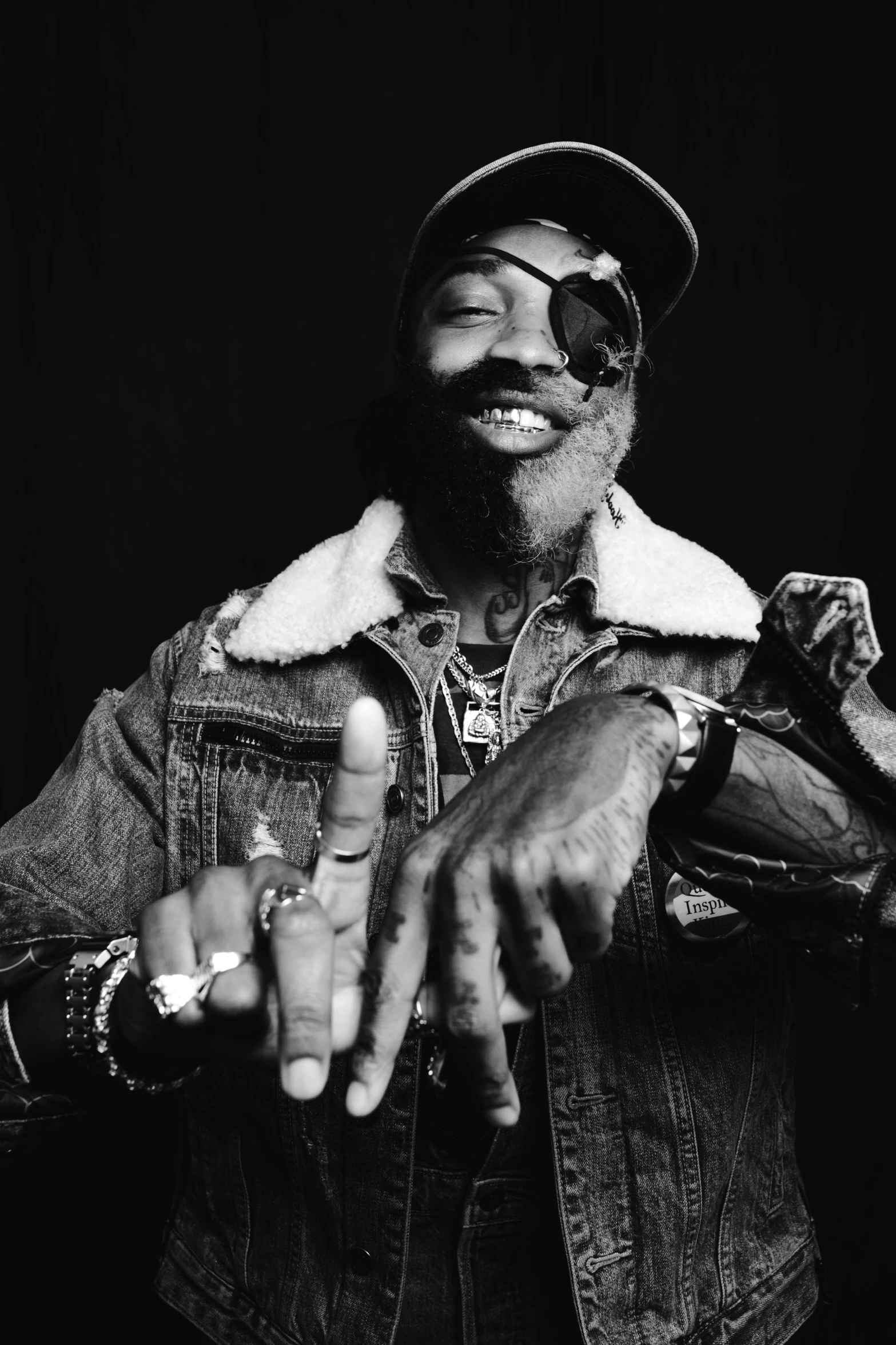 a black and white photo of a man in a denim jacket, by Charles Martin, george clinton, take my hand, happy birthday, black beard