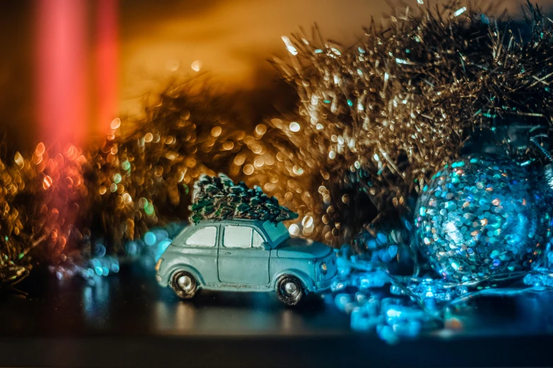 a toy car with a christmas tree on top of it, by Daniel Lieske, pexels contest winner, teal lights, hasselblad film bokeh, ornament, 15081959 21121991 01012000 4k