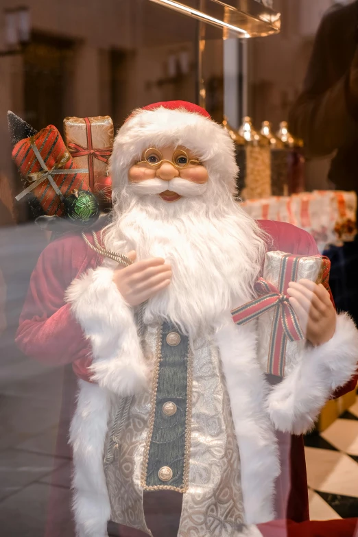 a close up of a santa figurine in a store window, a portrait, pexels, holding gift, gif, split near the left, decorations