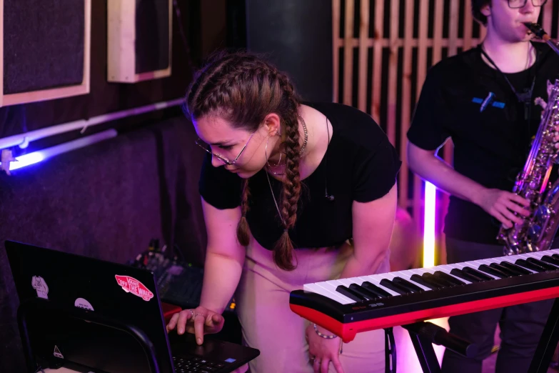 a group of people playing musical instruments in a room, small neon keyboard, charli bowater and artgeem, profile image, student