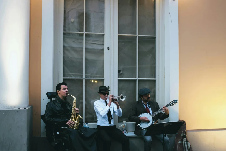 a group of men playing instruments in front of a window, top hats, classic vibes, al fresco, lit up