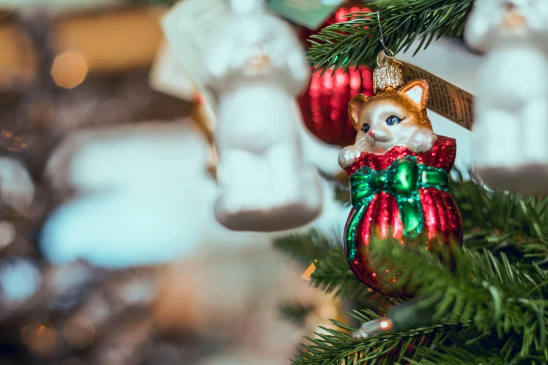 a close up of a christmas ornament on a tree, by Julia Pishtar, pexels, photo of a cat, figurines, multiple stories, gettyimages