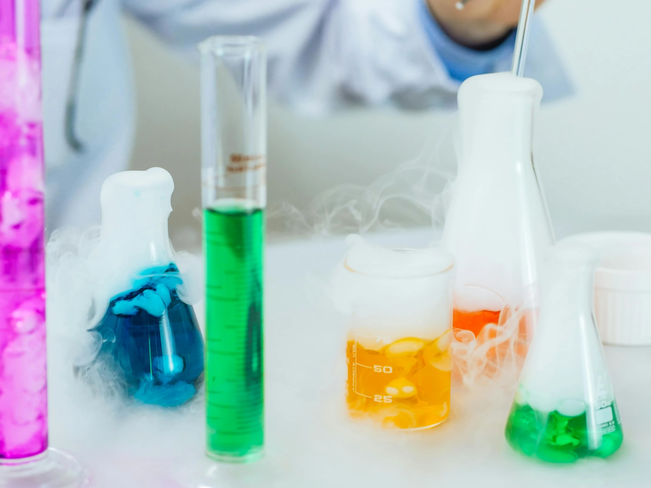 a close up of a person in a lab coat, trending on unsplash, process art, dry ice, background image, vases and bottles, liquid smoke