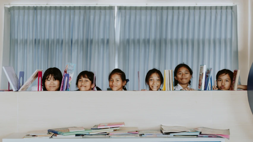 a group of children looking out of a window, a picture, by Kristian Zahrtmann, pexels contest winner, quito school, on a desk, standing on a shelf, in front of white back drop, serene smile