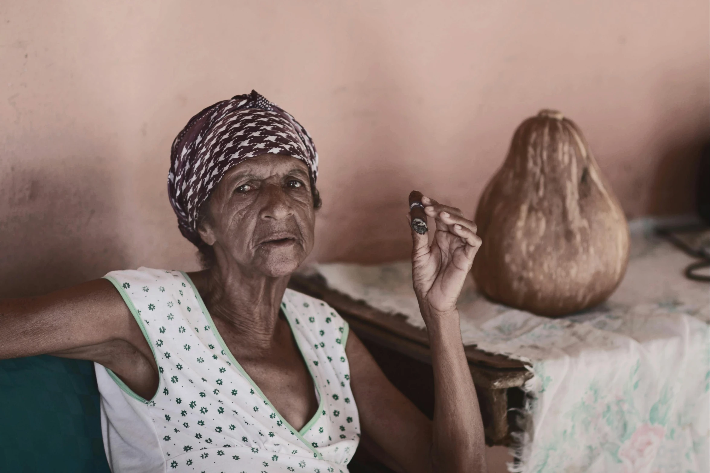 a woman sitting on a couch smoking a cigarette, a portrait, pexels contest winner, hyperrealism, she is a gourd, madagascar, old color photograph, with an intricate