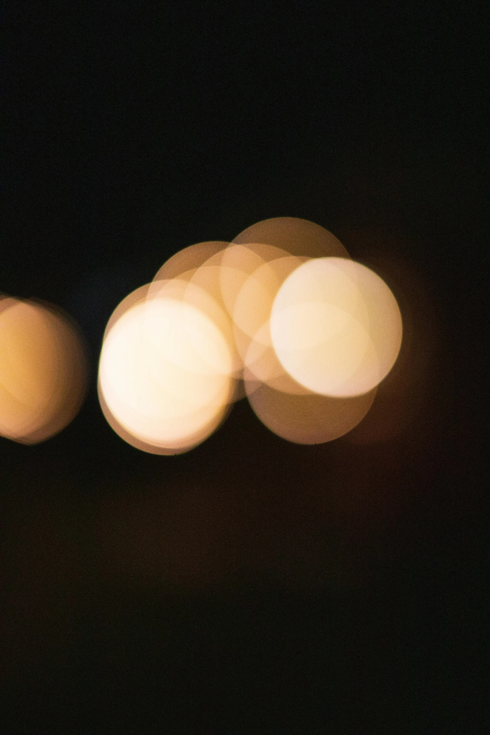 a blurry photo of some lights in the dark, a picture, inspired by Jan Rustem, unsplash, lyrical abstraction, two moons lighting, warm yellow lights, paul barson, dots abstract