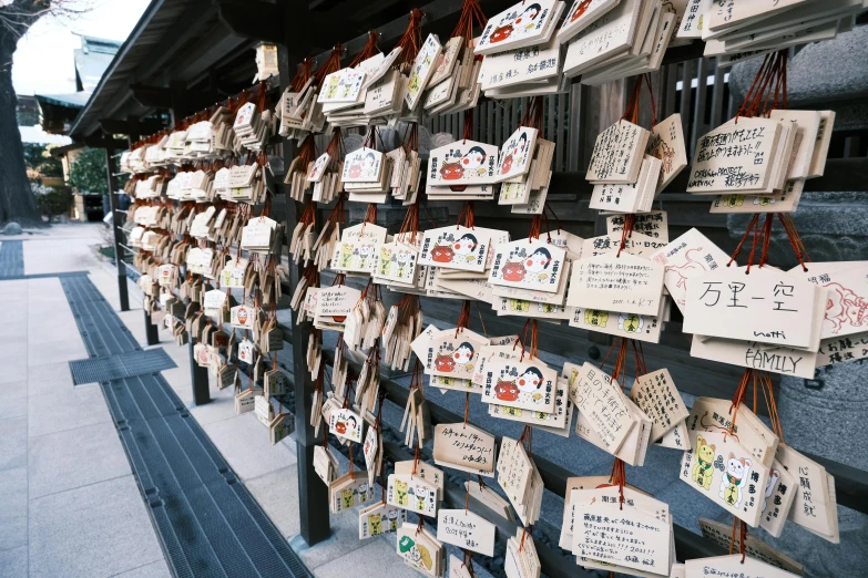 a bunch of tags hanging on the side of a building, unsplash, ukiyo-e, 🚿🗝📝