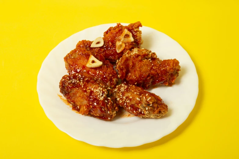 a white plate topped with chicken wings covered in sauce, by Ellen Gallagher, sōsaku hanga, kwak ji young, on clear background, yellow, fried chicken