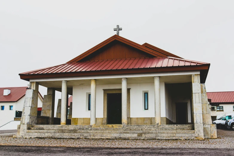 a small white building with a red roof, a photo, unsplash, catholic, shipibo, gray, square