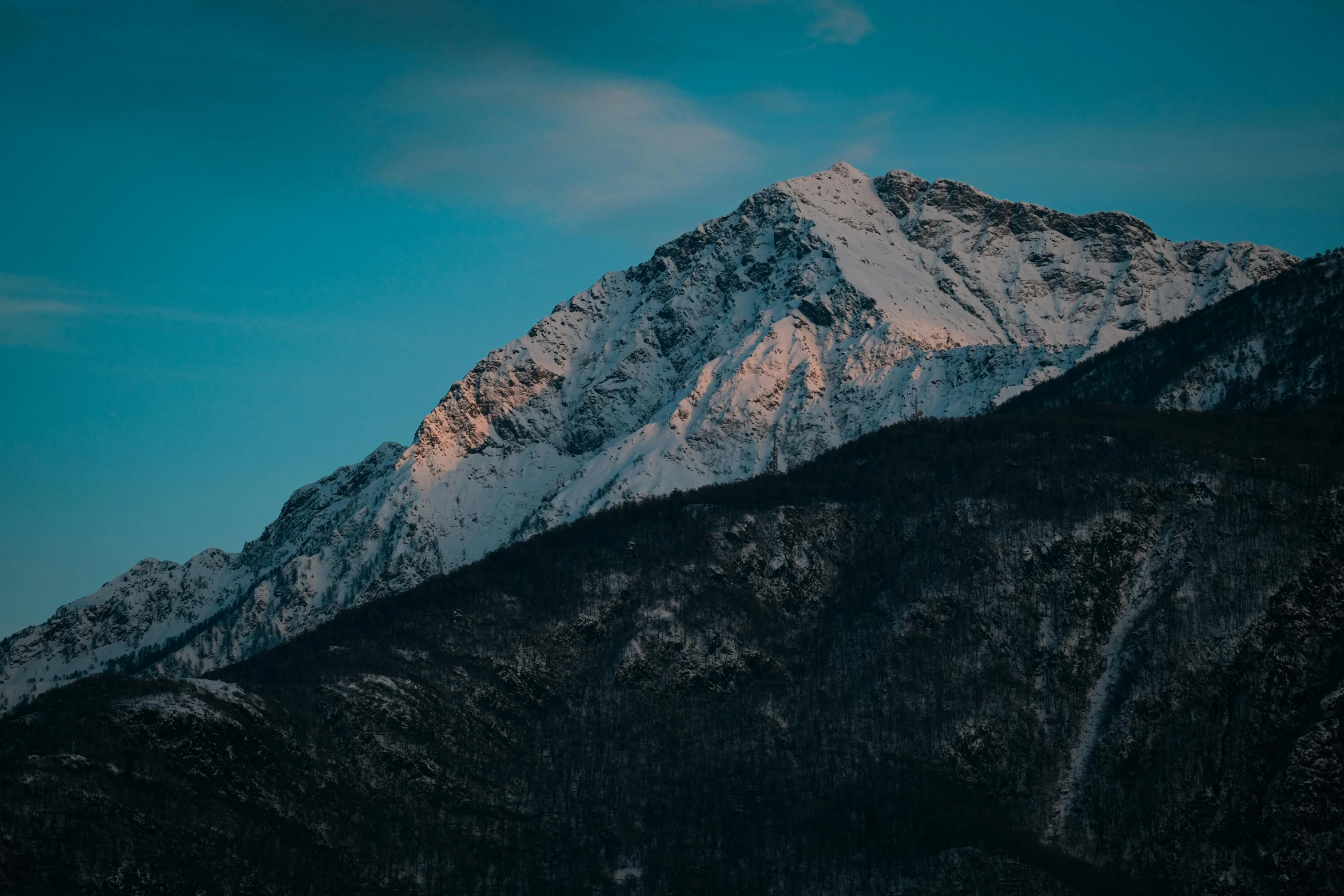 a mountain covered in snow under a blue sky, a picture, unsplash contest winner, filtered evening light, portrait mode photo, craggy, 4 k hd wallpapear