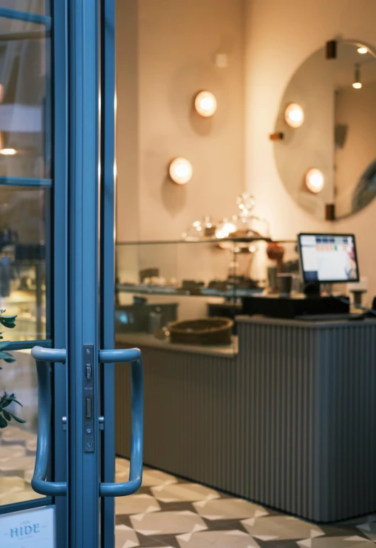 a view of a coffee shop through a glass door, inspired by Albert Paris Gütersloh, unsplash, art nouveau, blue soft details, at the counter, private academy entrance, thumbnail