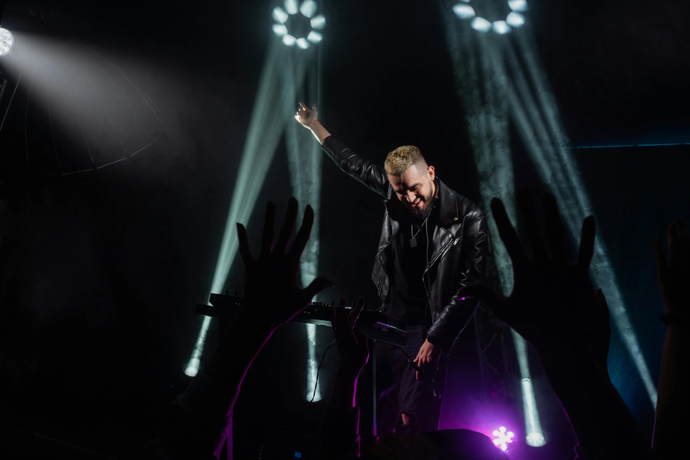 a man standing on top of a stage in front of a crowd, wearing a black leather jacket, show light, marshal mathers, avatar image