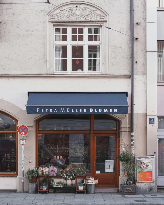 a flower shop on the corner of a street, by Anton Möller, pexels contest winner, art nouveau, pat steir and hilma af klint, shop front, restaurant, prussian blue