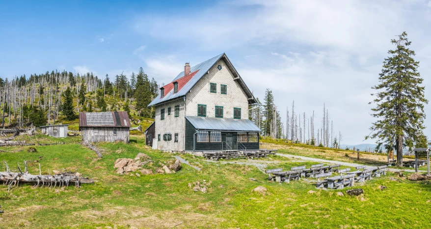 a house sitting on top of a lush green hillside, by Dietmar Damerau, pexels contest winner, old lumber mill remains, elevation view, panoramic, hut