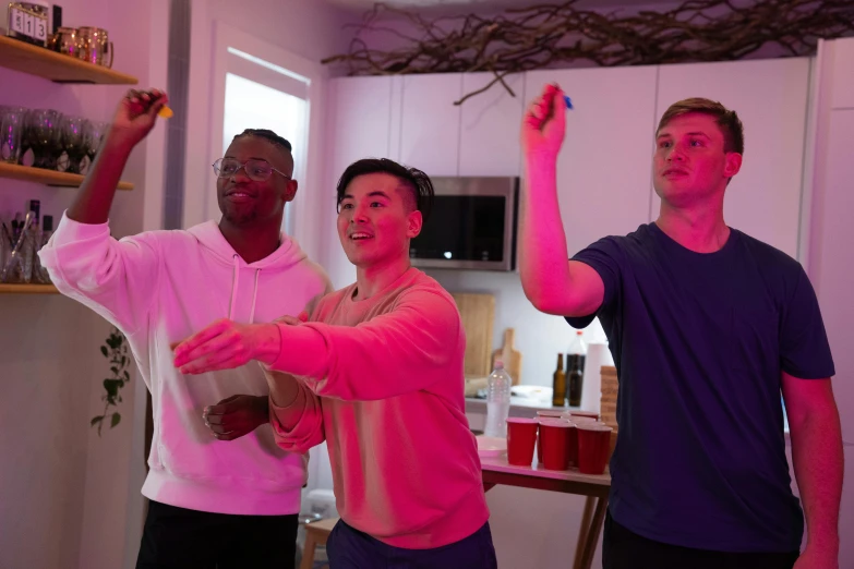 three men standing next to each other in a kitchen, happening, dance party, gaming, airbnb, multiple lights