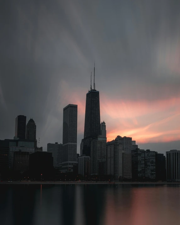 a large body of water with a city in the background, by Jacob Burck, pexels contest winner, stormy setting, chicago, lgbtq, album cover