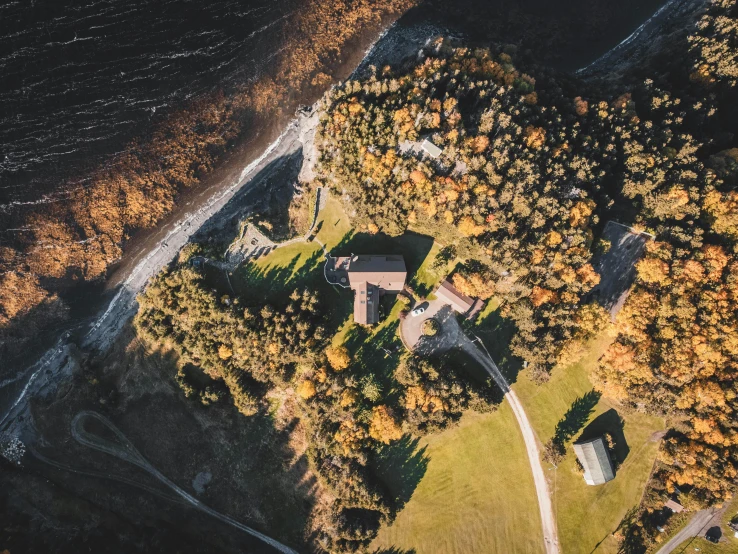 an aerial view of a house surrounded by trees, by Sebastian Spreng, pexels contest winner, castle on the mountain, thumbnail, norway, brown