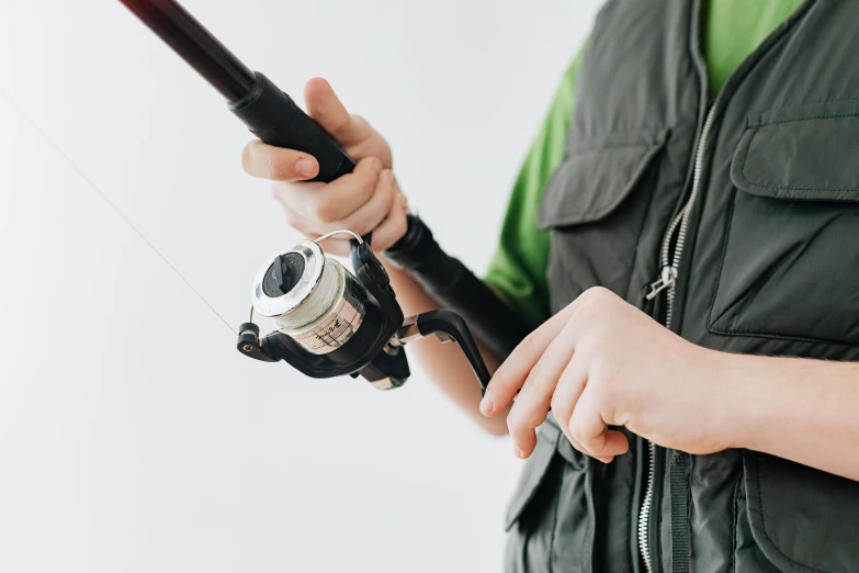 a close up of a person holding a fishing rod, profile picture