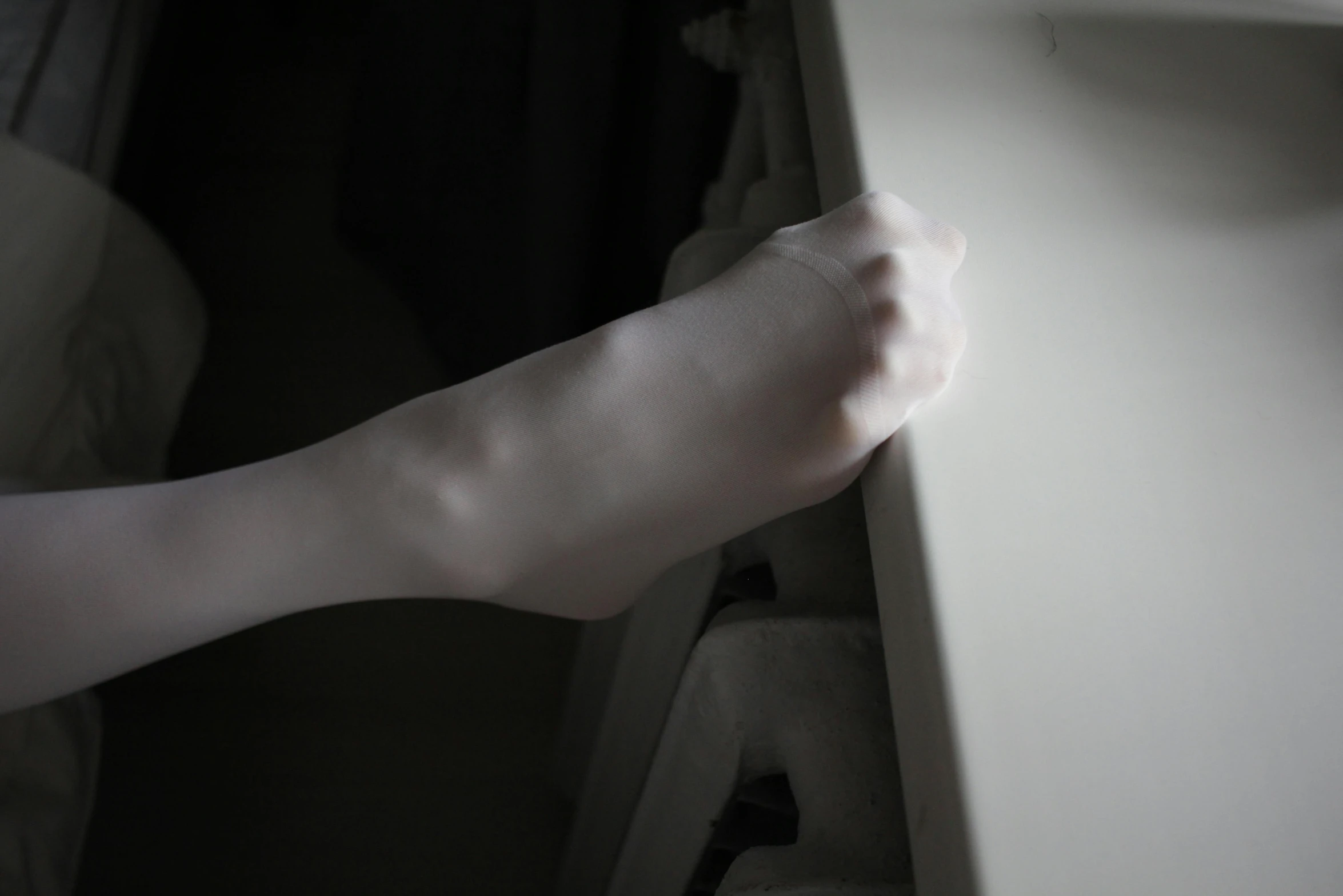 a person's feet sticking out of a window sill, a statue, inspired by Gottfried Helnwein, hyperrealism, close-up of thin soft hand, intense albino, fight pose, out in the dark