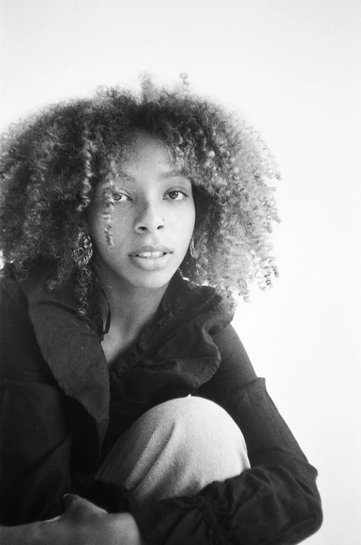 a black and white photo of a woman with curly hair, by Clifford Ross, sza, taken in the mid 2000s, square, leonora karrington