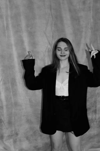 a black and white photo of a woman posing for a picture, a black and white photo, tumblr, 🐿🍸🍋, joey king, hand gestures, in style of britt marling