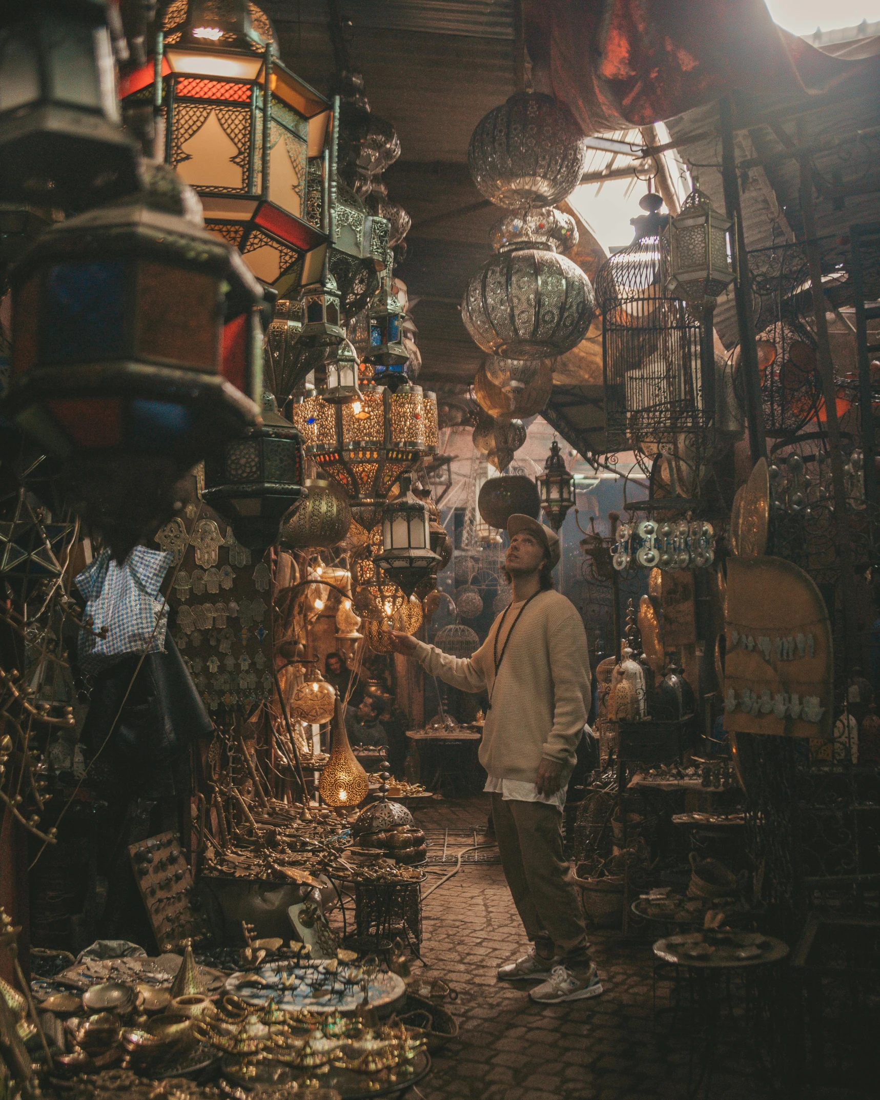 a man standing in the middle of a market, trending on unsplash, renaissance, morrocan lamp, shelves full of medieval goods, gif, glittering