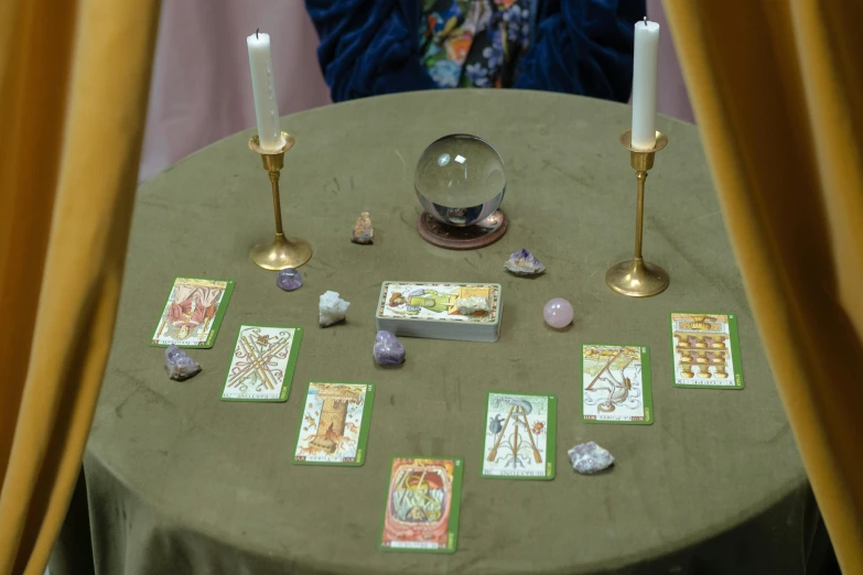 a table with candles and tarot cards on it, slide show, fan favorite, album, deity)