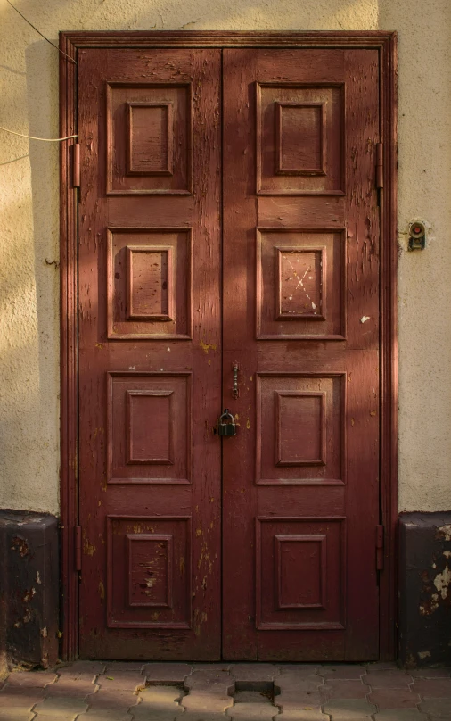 a red door sitting on the side of a building, by Konrad Witz, renaissance, muted brown, square, cinematic front shot, an old