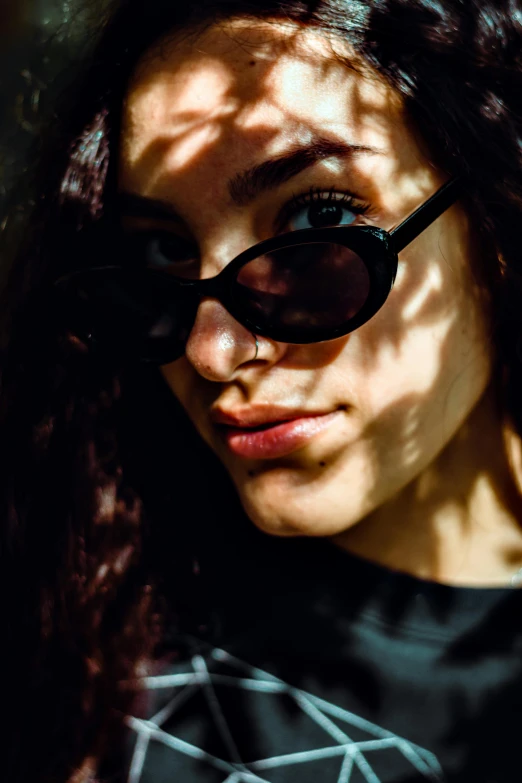 a close up of a person wearing sunglasses, a picture, young woman with long dark hair, light and shadow, promo image, high contrast portra 400