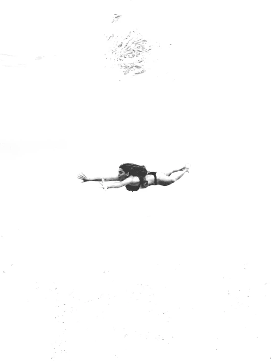 a black and white photo of a person swimming, an album cover, airborne view, ( ( photograph ) ), unknown title, 1981 photograph