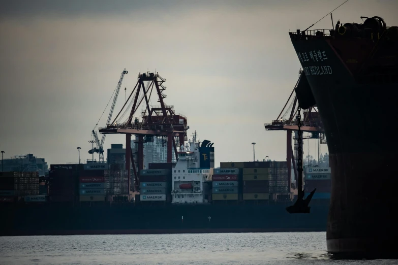 a large cargo ship sitting on top of a body of water, by Matt Stewart, pexels contest winner, cranes, extra detail, thumbnail, still frame