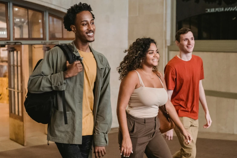 a group of young people walking down a sidewalk, trending on pexels, renaissance, with brown skin, background image, student, 3 actors on stage