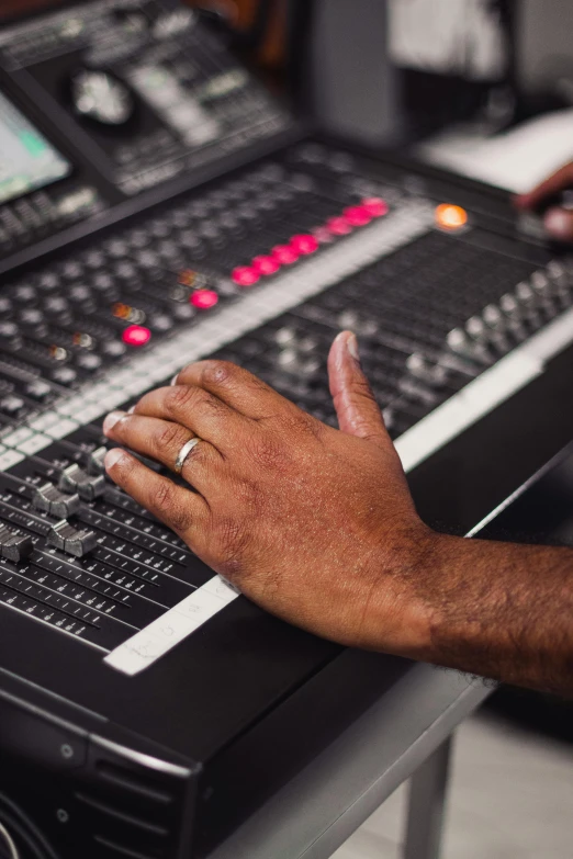 a close up of a person's hand on a sound board, an album cover, pexels, happening, diversity, engineering, a photo of a man, theatre equipment