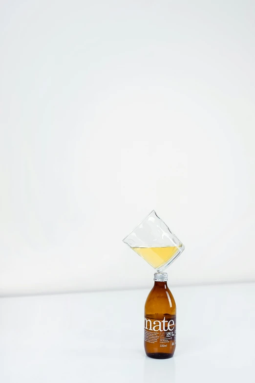 a bottle of beer sitting on top of a table, by Nathalie Rattner, crystal cubism, scientific glassware, diamond, syrup, minimalist