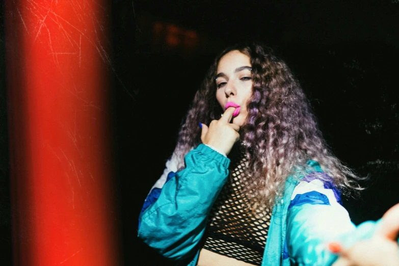 a woman with long curly hair talking on a cell phone, an album cover, inspired by Elsa Bleda, trending on pexels, graffiti, night clubs and neons, hailee steinfeld, tongue out, bisexual lighting
