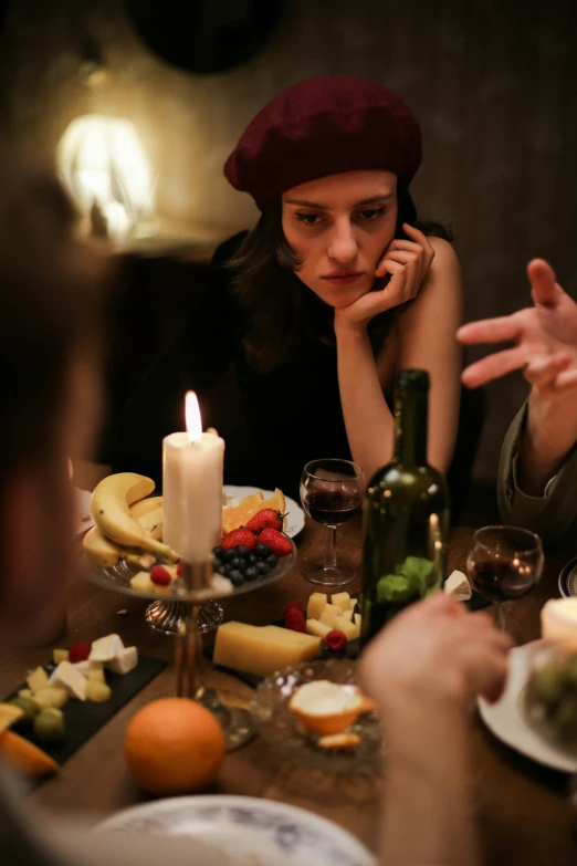 a couple of people that are sitting at a table, trending on pexels, renaissance, scene from a dinner party, sad scene, wearing a french beret, candle lit